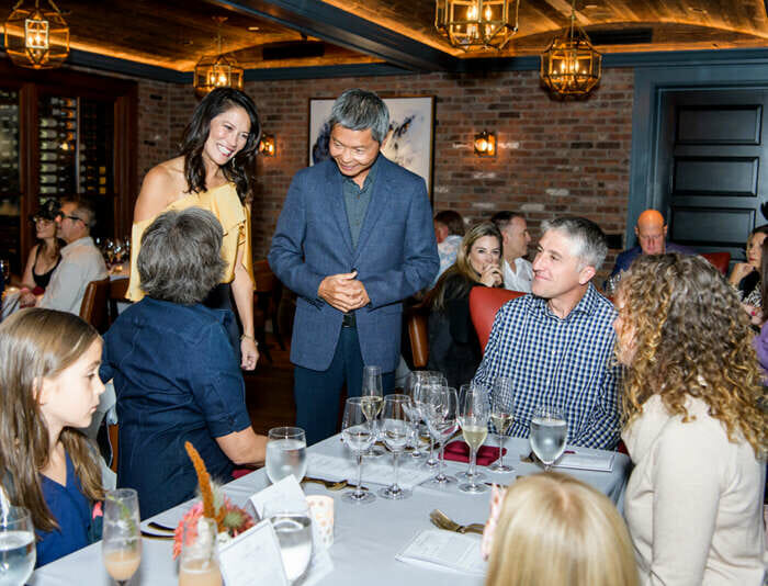 Jean Wong and Bernard Chiu chatting with friends at a food and wine dinner event at the Harbor View Hotel on Martha's Vineyard.