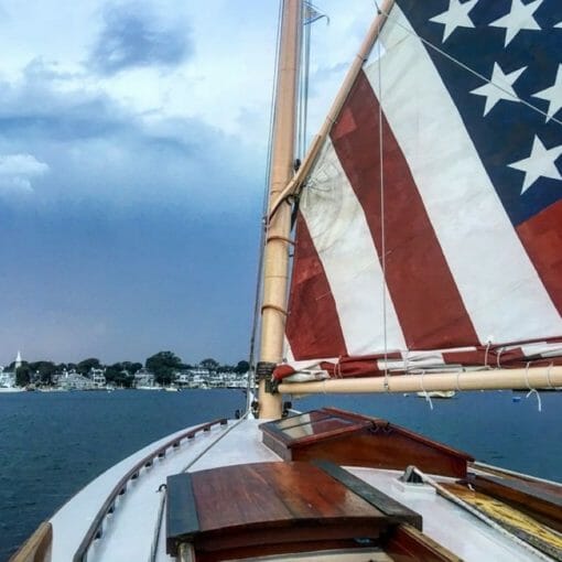 Sailboat with American flag sailing in Edgartown, Massachusetts, on Martha's Vineyard.