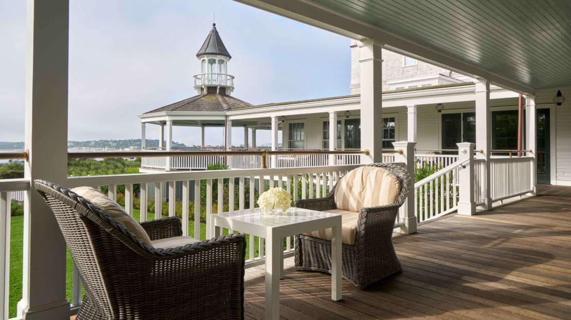 Seating on the Veranda at the Harbor View Hotel with a view Edgartown Harbor.