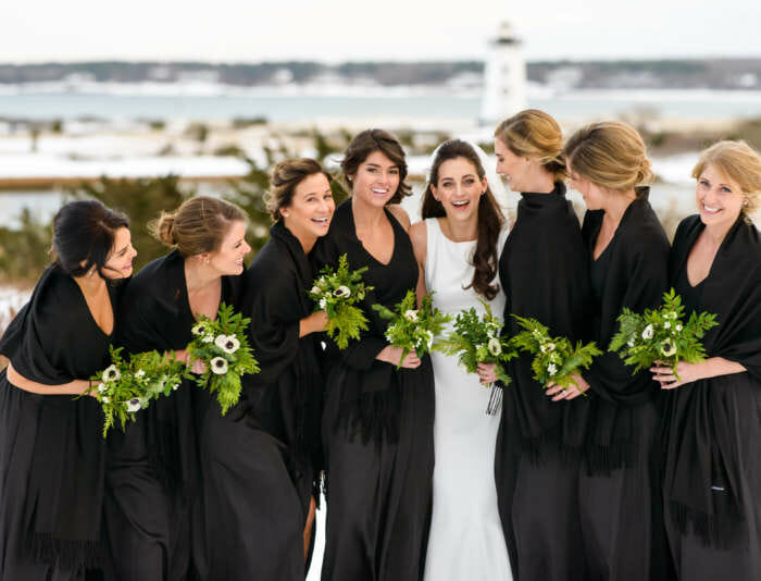 Bride and bridesmaids taking photos outside in winter at Harbor View Hotel.