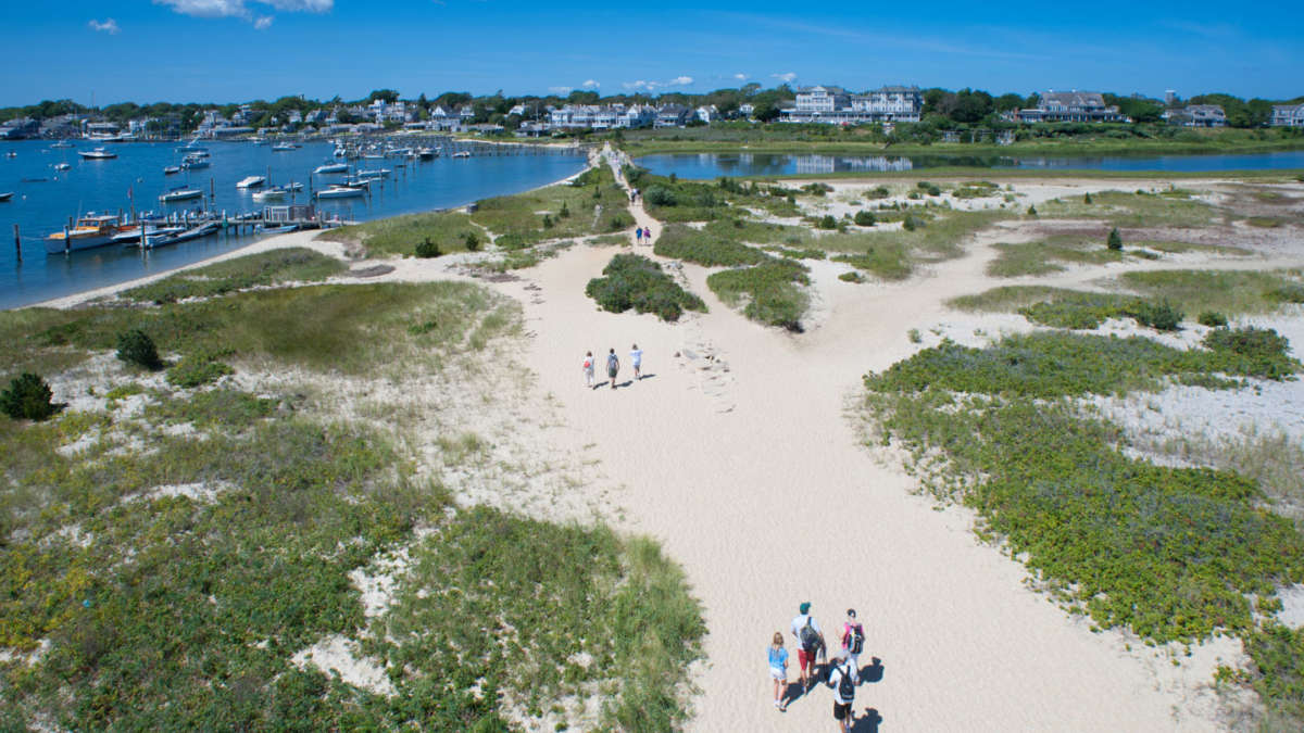 Drone view of people walking towards lighthouse beach on Martha's Vineyard.