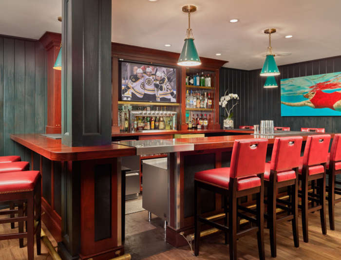 The Clubhouse bar at Bettini with stool seating and the Bruins playing in the background TV.