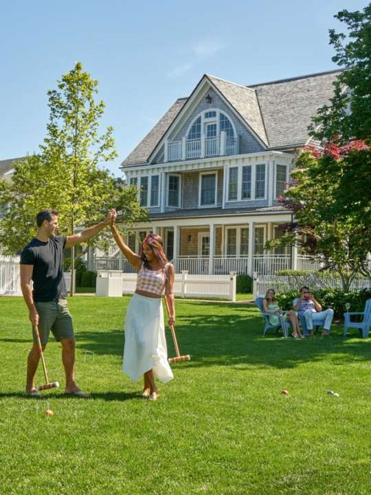 Couple walking on cottage lawn together