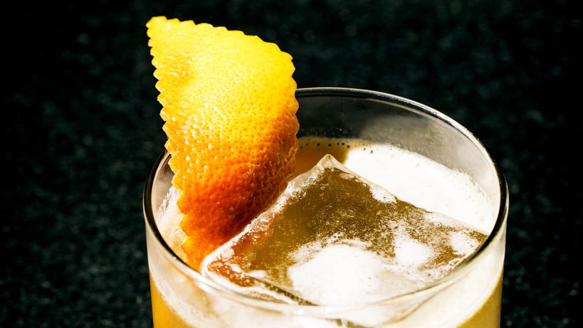 Drink with ice cube and wedge of lemon