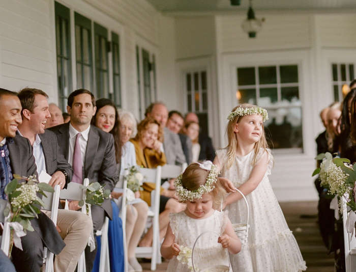 Flower girls walking down Harbor View Veranda for a wedding.