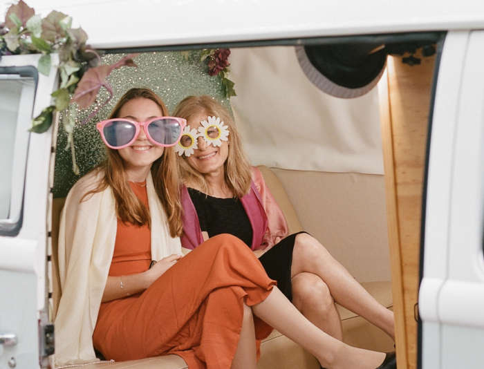 Guests with props in the photo booth van at Harbor View Hotel.