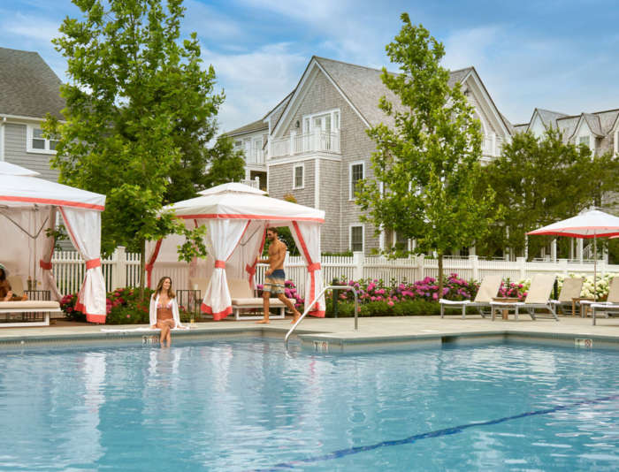 A couple sitting by the Harbor View Hotel outside heated pool.