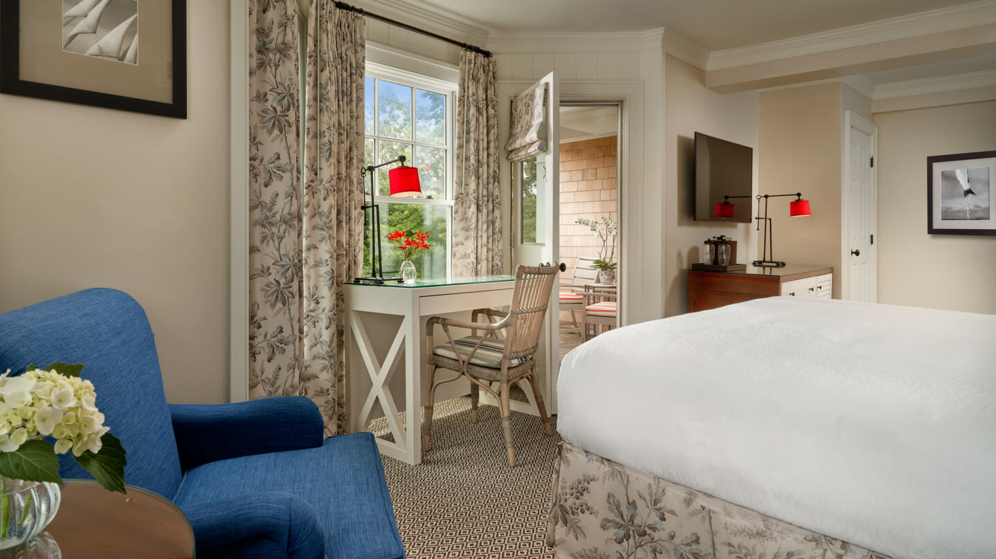A historic guest room with a king bed and desk at the Harbor View Hotel.