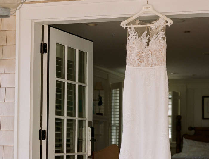 Wedding dress hanging on a Captain's Cottage door frame.