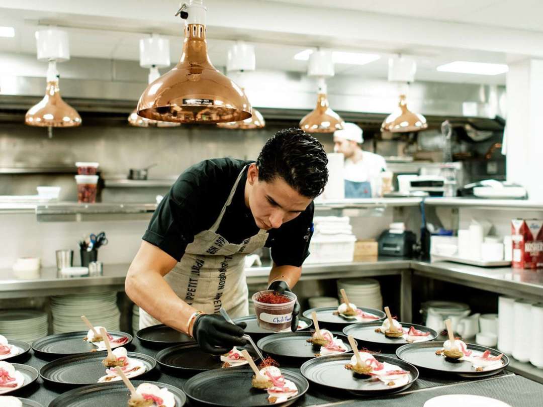 Chef Alex Pineda putting finishing touches on a dish in the kitchen