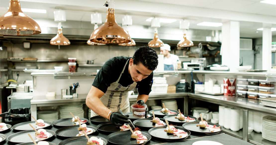 Chef Alex Pineda putting finishing touches on a dish in the kitchen