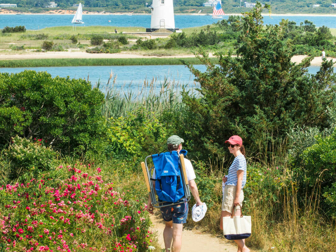 A couple walking down to the Edgartown Lighthouse.