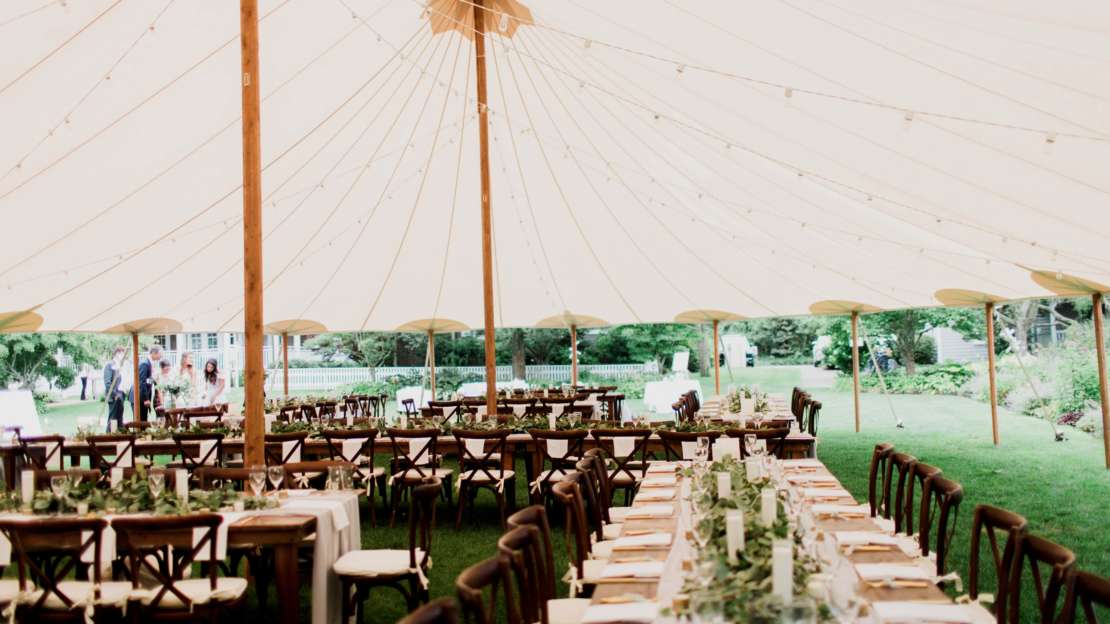 Tables under a tent set up for a wedding