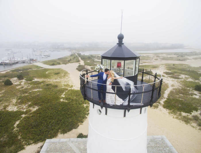 Bride and groom kissing at the top of the Edgartown lighthouse.