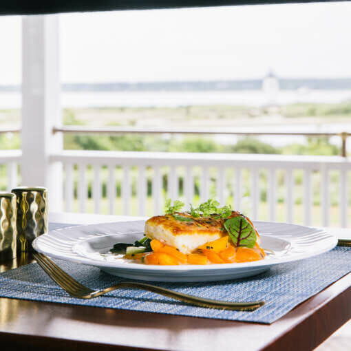 A white fish dish at the Bettini Restaurant with a view of Edgartown Lighthouse.