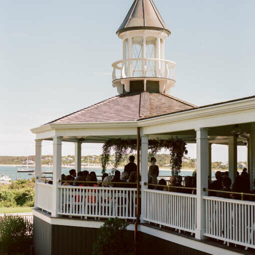 A couple exchanging their vows on the veranda at Harbor View Hotel overlooking the ocean.
