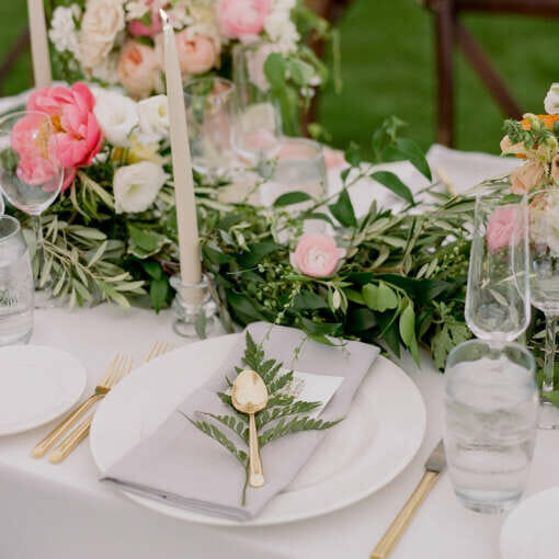 A wedding tablescape with pink flowers and candles at Harbor View Hotel.