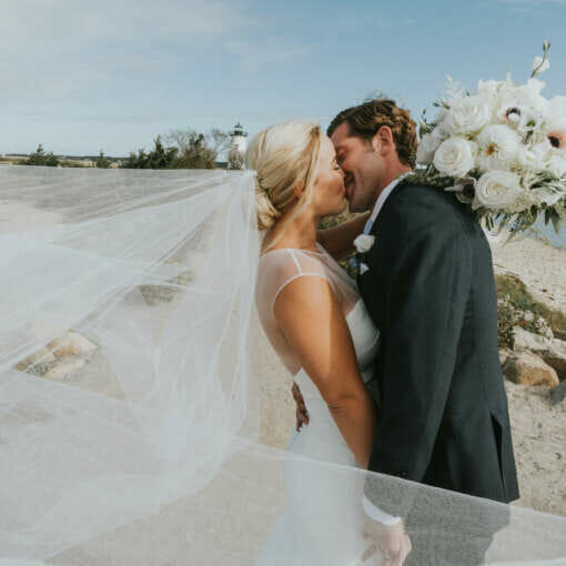 A bride and groom kissing on the beach in Edgartown.