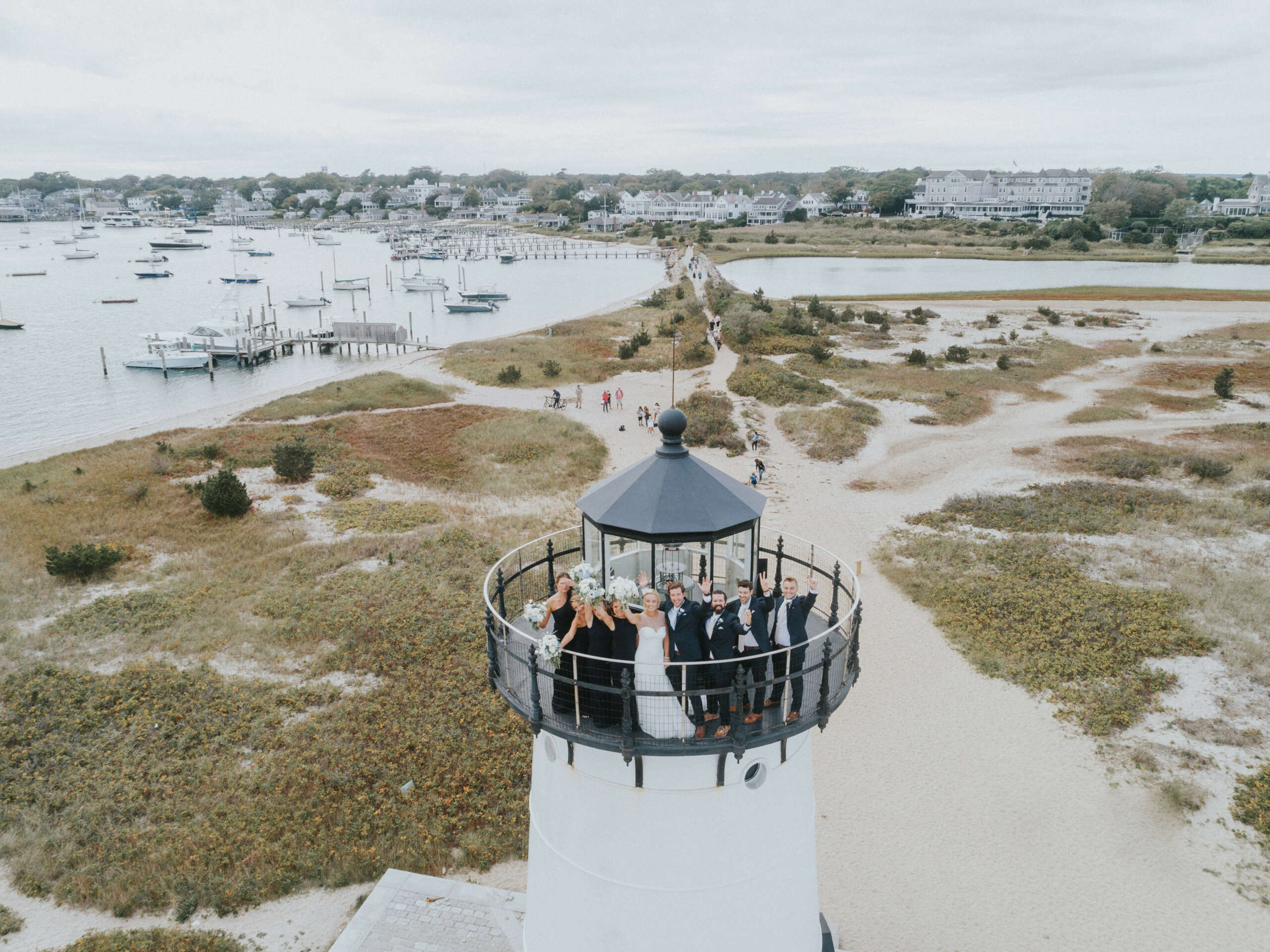 A wedding couple and party on top of the Edgartown Lighthouse.