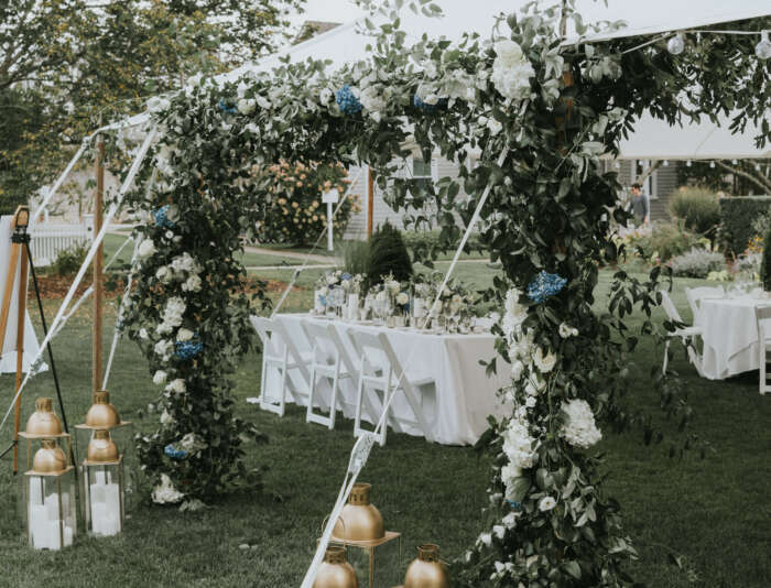 A wedding tent decorated with flowers and lanterns at Harbor View Hotel.