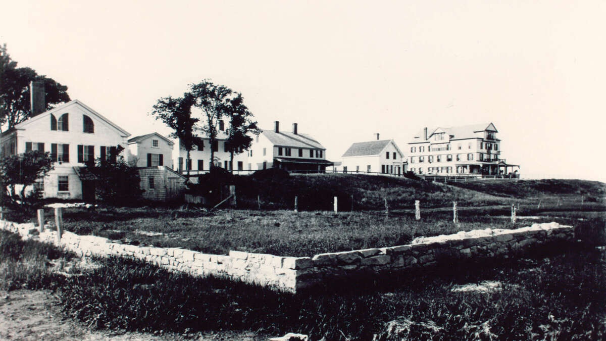 A black and white photo of five homes next to each other.