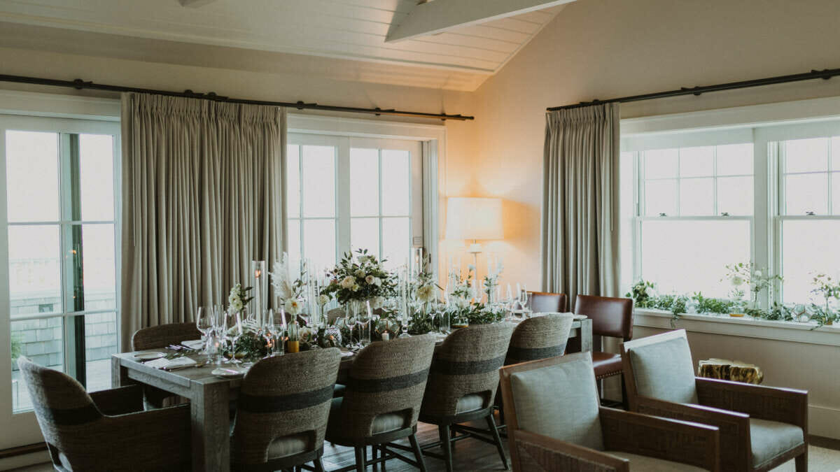 A table setting with chairs and flowers in the Skyhouse dining room.