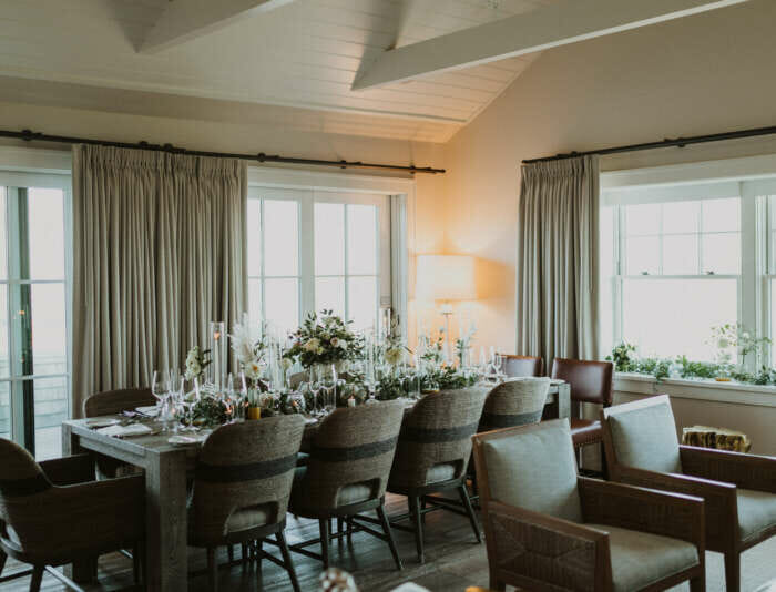 A table setting with chairs and flowers in the Skyhouse dining room.