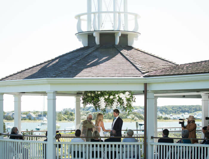 A bride and groom getting married on the Veranda at Harbor View Hotel.