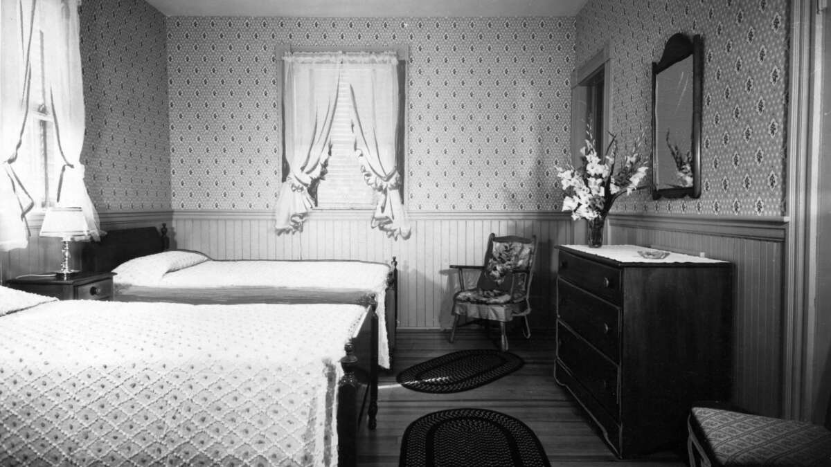 black and white photo of two beds
