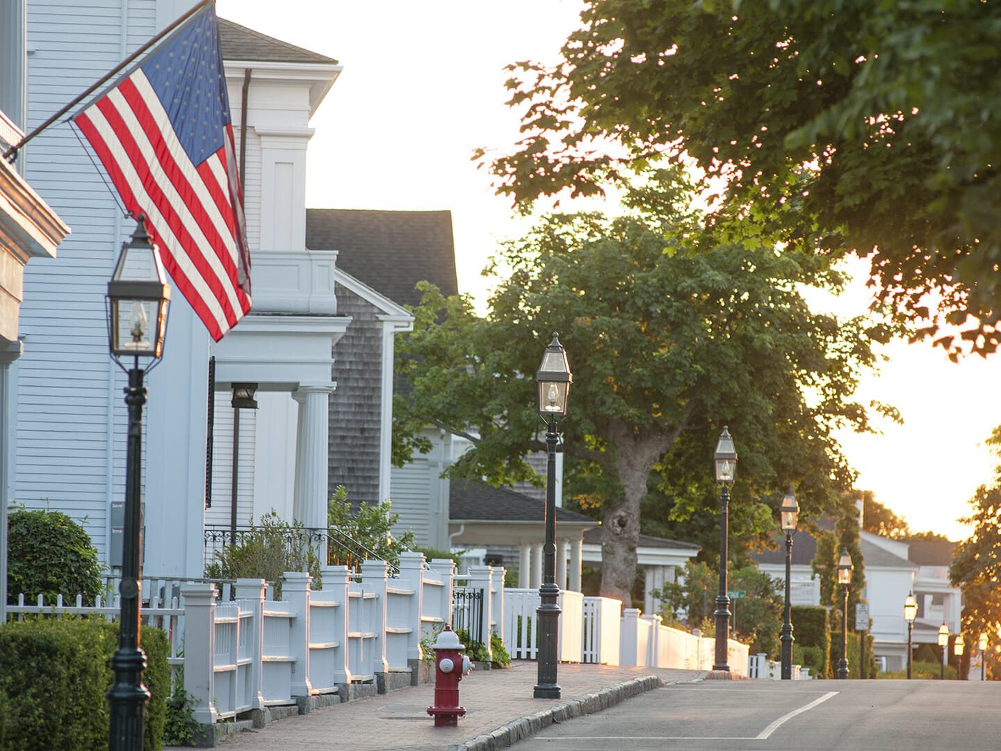 a street with lamps and an american flag