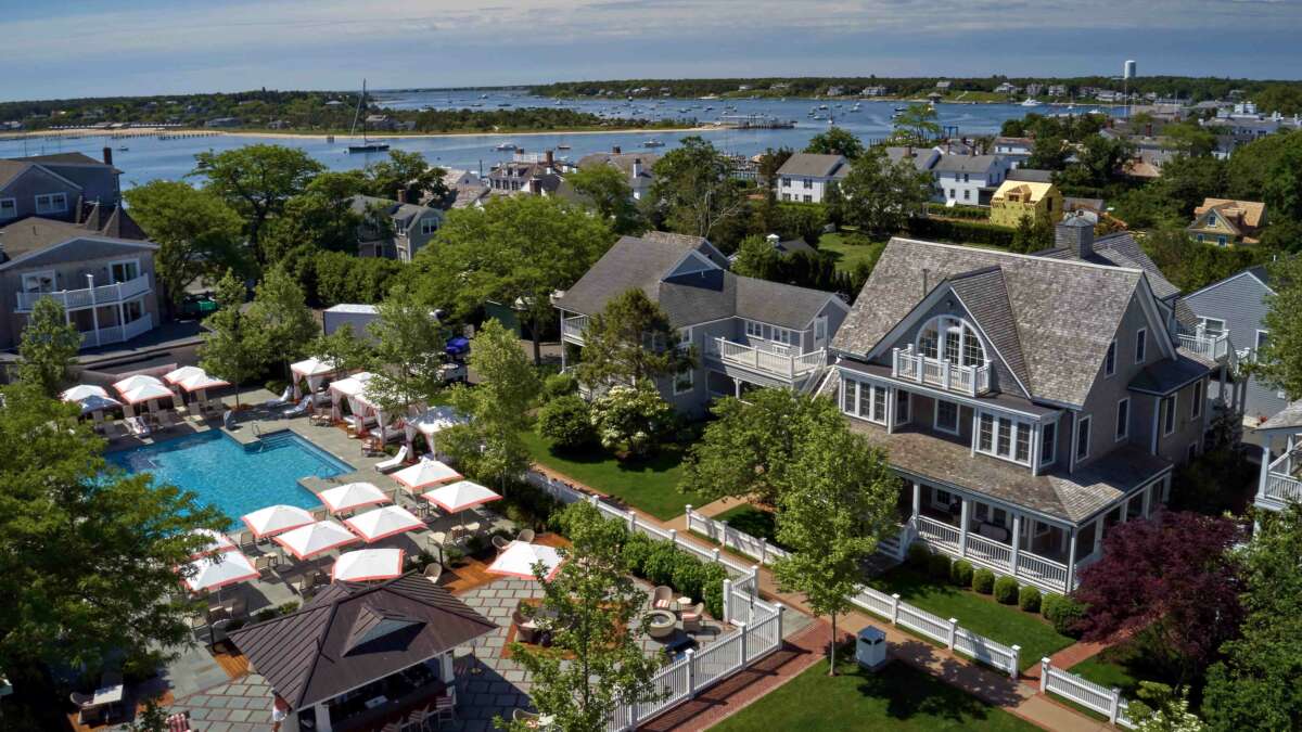 An aerial view of homes and cottages, a swimming pool, and the Edgartown Harbor from Harbor View Hotel.