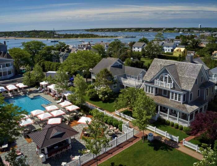 An aerial view of homes and cottages, a swimming pool, and the Edgartown Harbor from Harbor View Hotel.