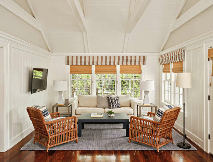 A Captain's Cottage living room with a cathedral ceiling at Harbor View Hotel.