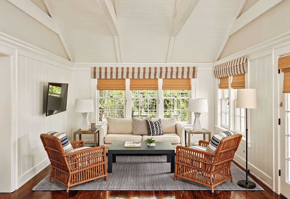 A Captain's Cottage living room with a cathedral ceiling at Harbor View Hotel.