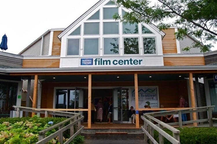 a building with glass windows and says MV film center in blue writing