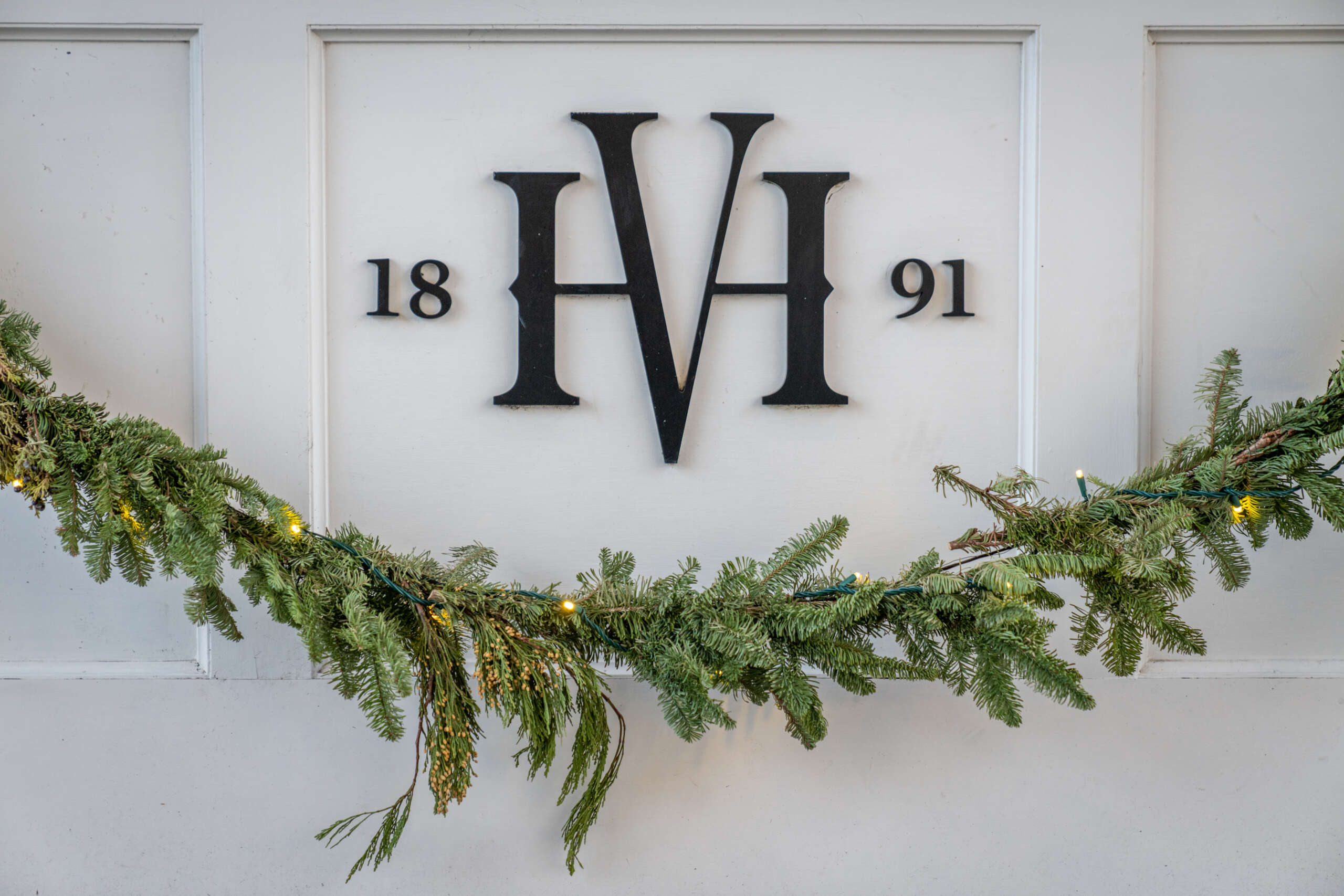 A HVH emblem and garland at the Harbor View Hotel during the winter.