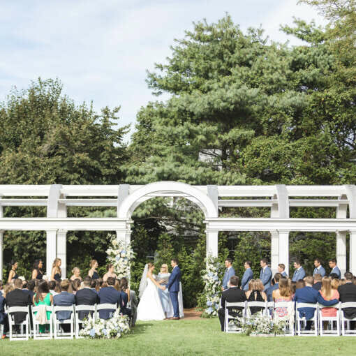 A wedding on the great lawn in front of the pergola at Harbor View Hotel on Martha's Vineyard.