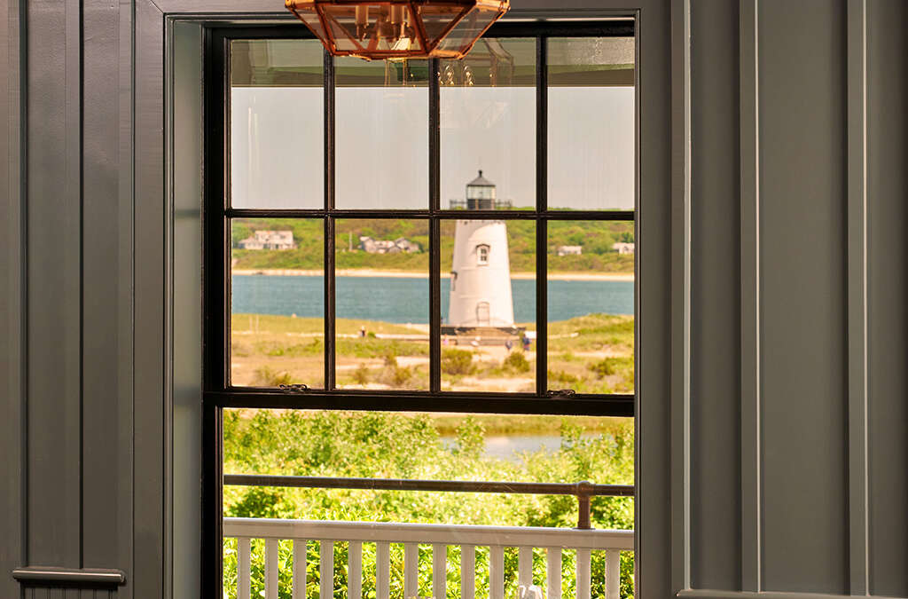 A table set for dinner at Bettini Restaurant at the Harbor View Hotel with a view of Edgartown Lighthouse.