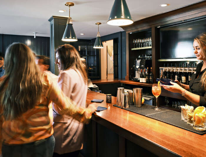 People chatting and drinking at The Clubhouse at Bettini Restaurant on Martha's Vineyard.