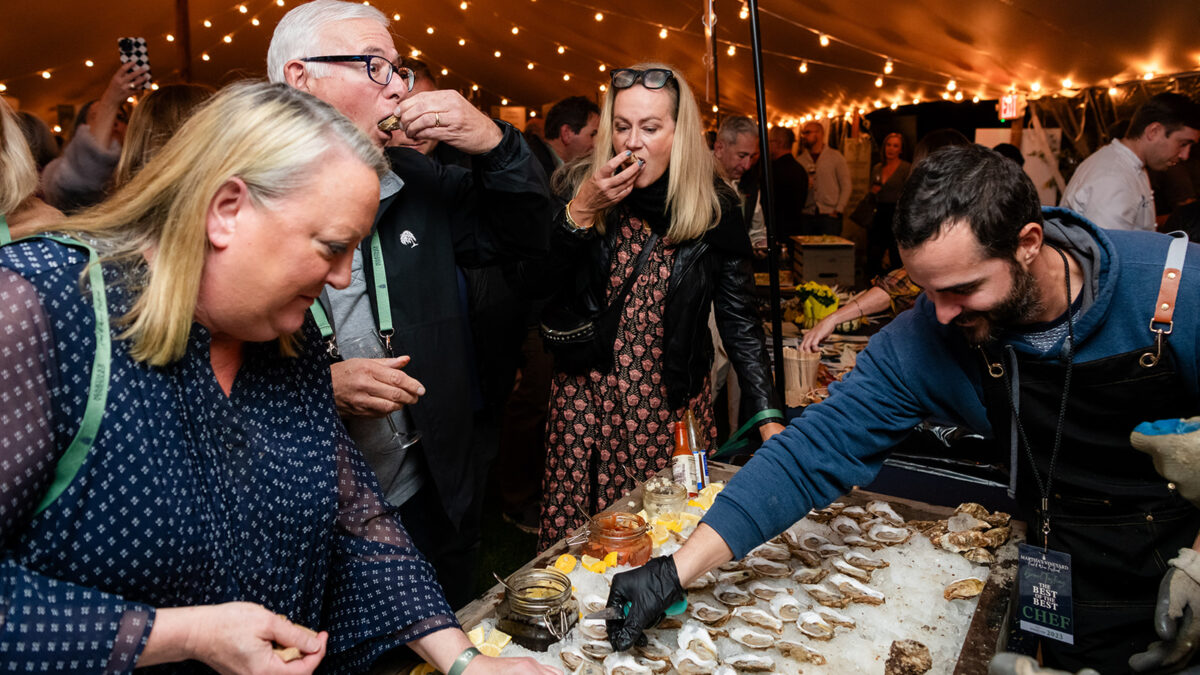 Guests tasting oysters at the 2023 Martha's Vineyard Food & Wine Festival at Harbor View Hotel.