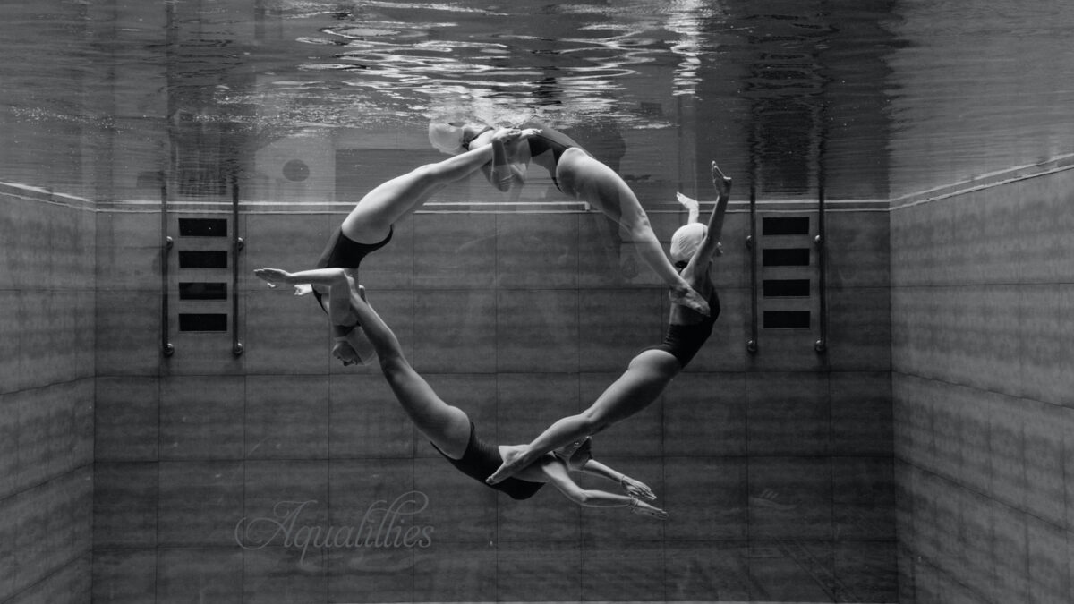 View of Aqualillies performers in the pool from under the water forming a perfect circle.