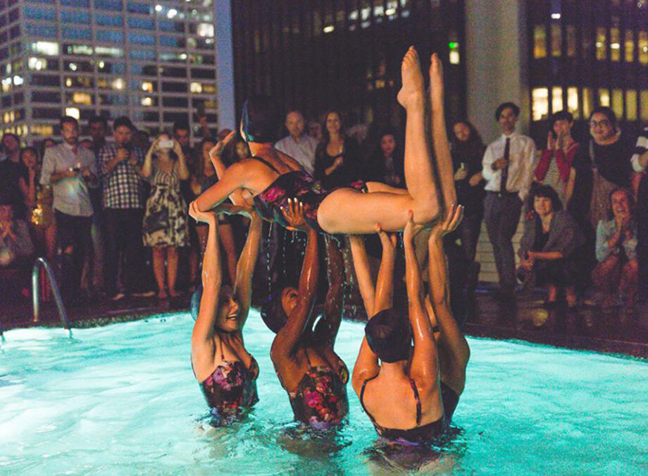 Aqualillies performers lifting a swimmer in the air.