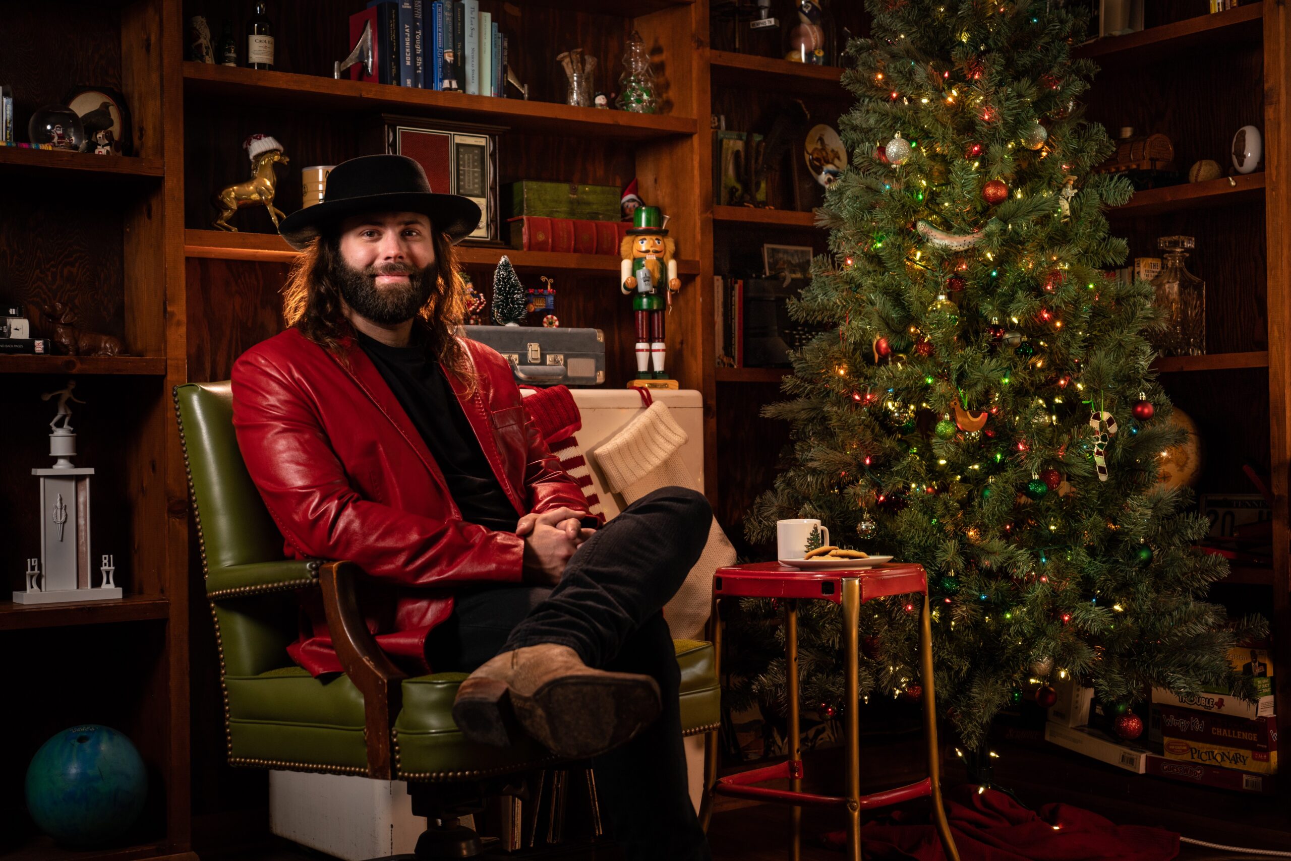 CJ Solar sitting next to a christmas tree.